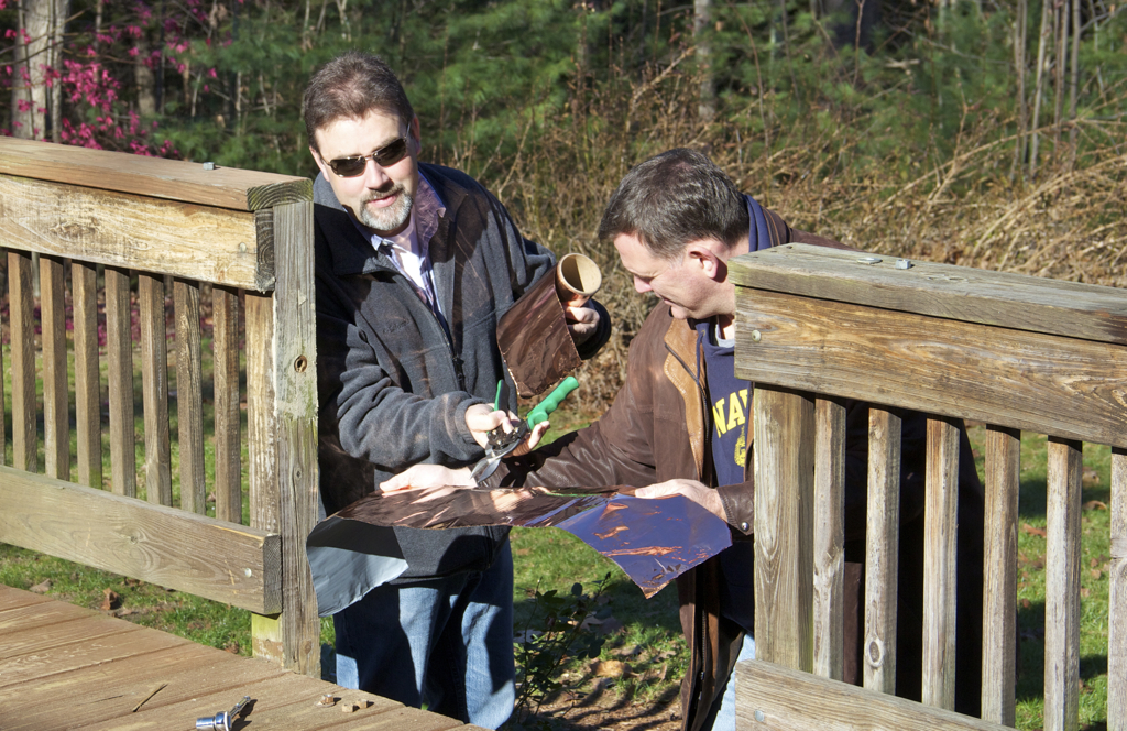 1st step of stair replacement on the deck is copper kickplate with Walshie and Claude lending a hand...